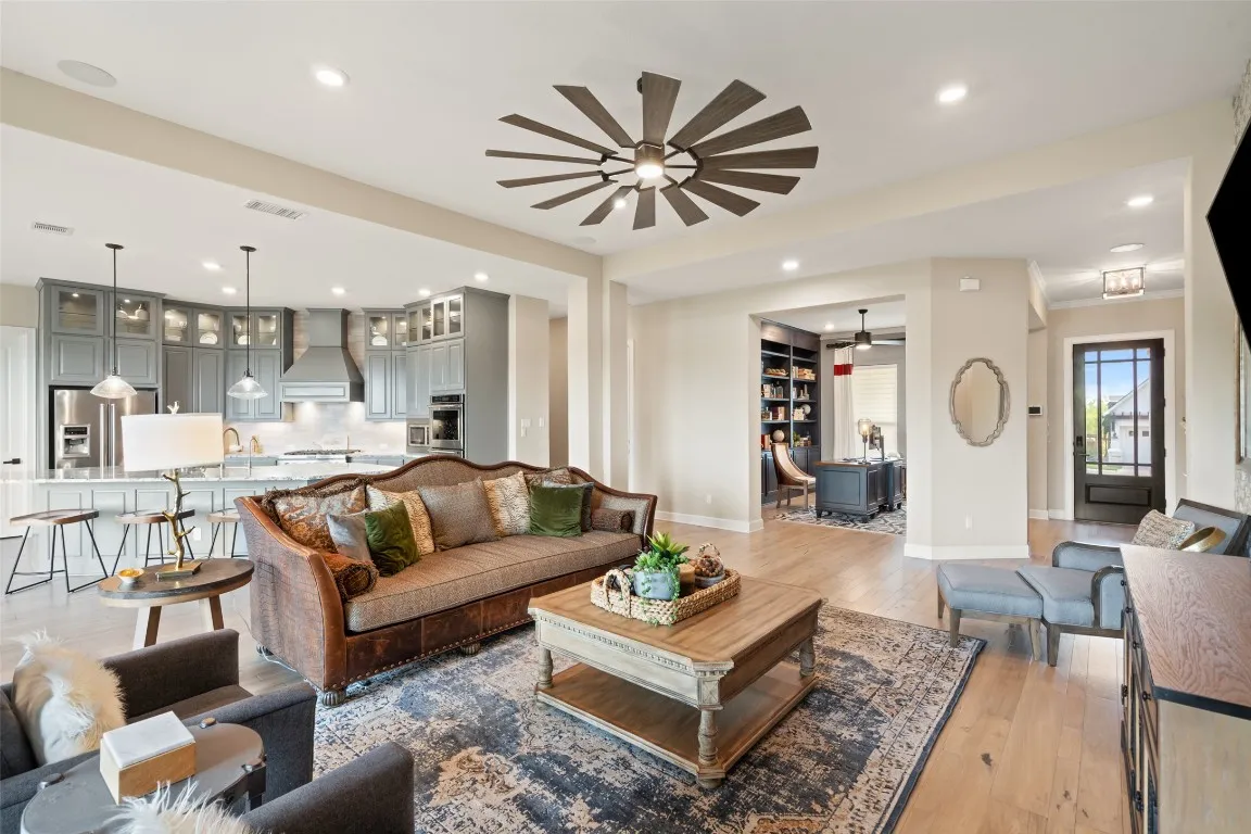 a living room with furniture a ceiling fan and a rug