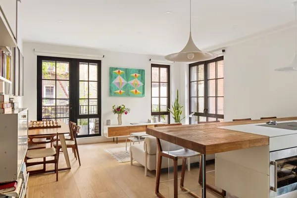 a dining room with a window table and chairs