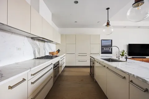 a large kitchen with stainless steel appliances granite countertop a sink and a stove