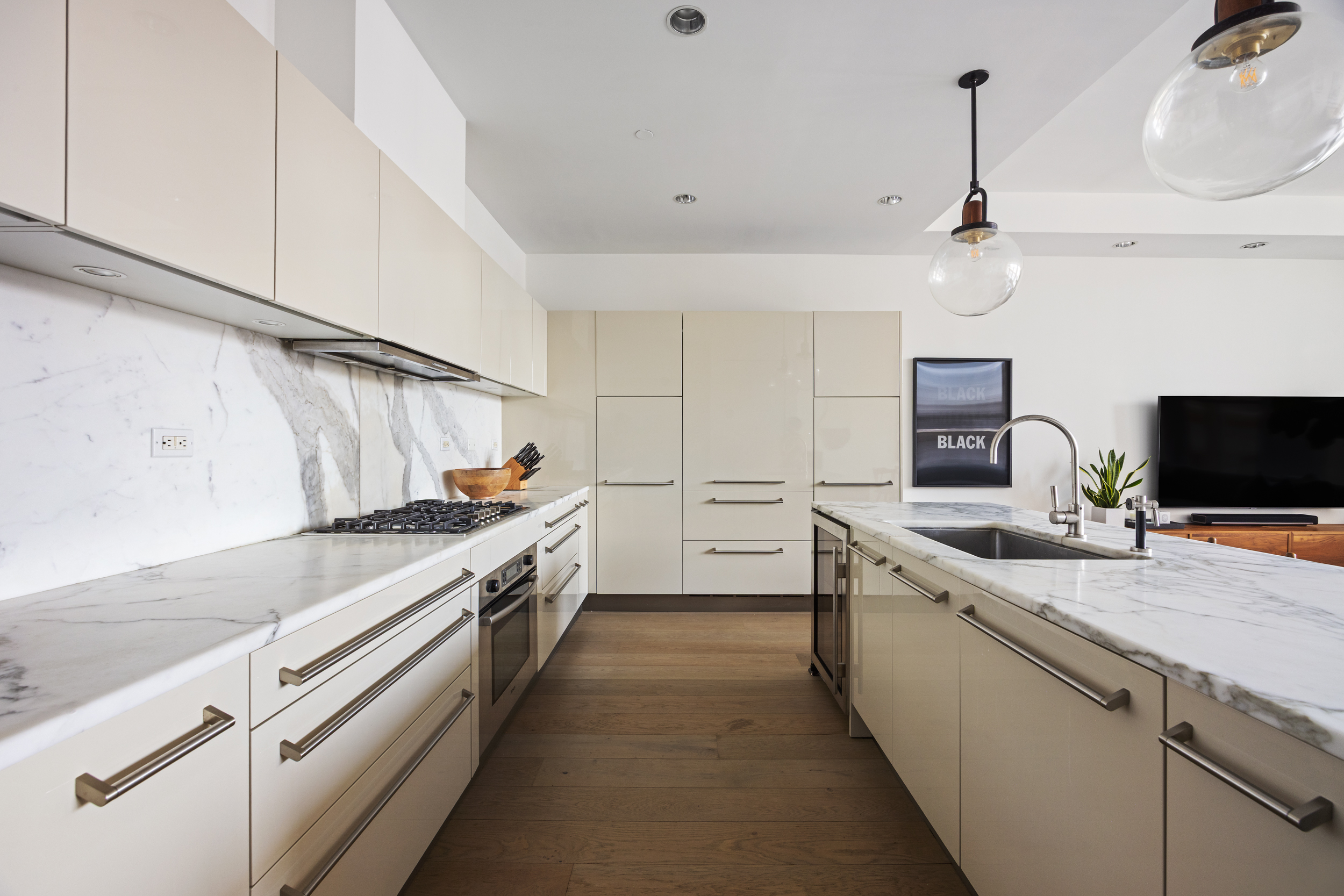 51 Walker Street, Unit 8B Manhattan, NY 10013 - Photo 7 of 15 a large kitchen with stainless steel appliances granite countertop a sink and a stove