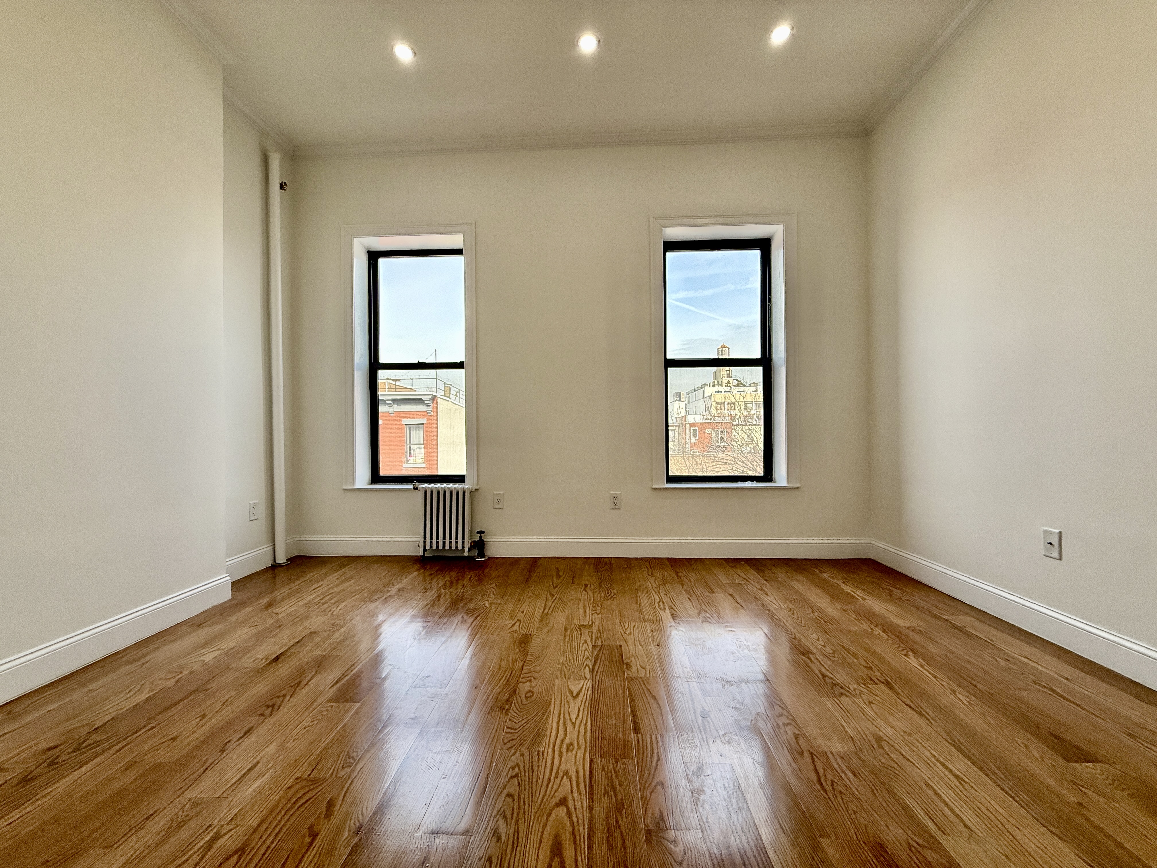 172 Union Street, Unit 4R Brooklyn, NY 11231 - Photo 6 of 9 an empty room with wooden floor and windows