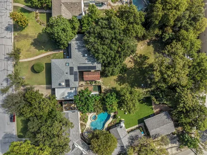 an aerial view of a house with a yard and garden