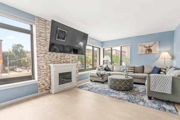 a living room with furniture and a fireplace