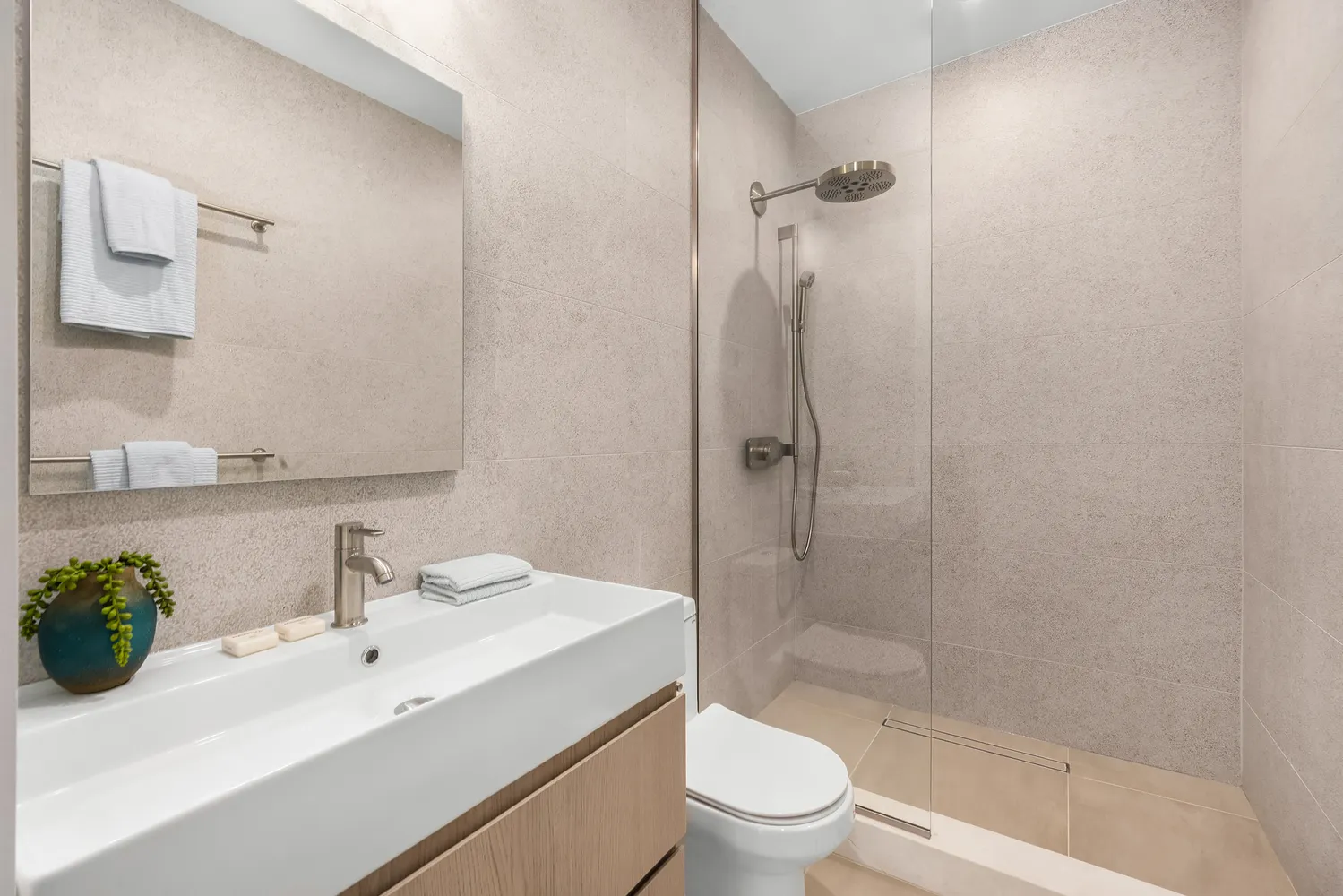 a bathroom with a sink toilet and shower