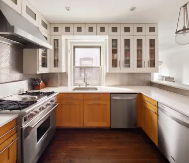 a kitchen with stainless steel appliances granite countertop a stove and a sink