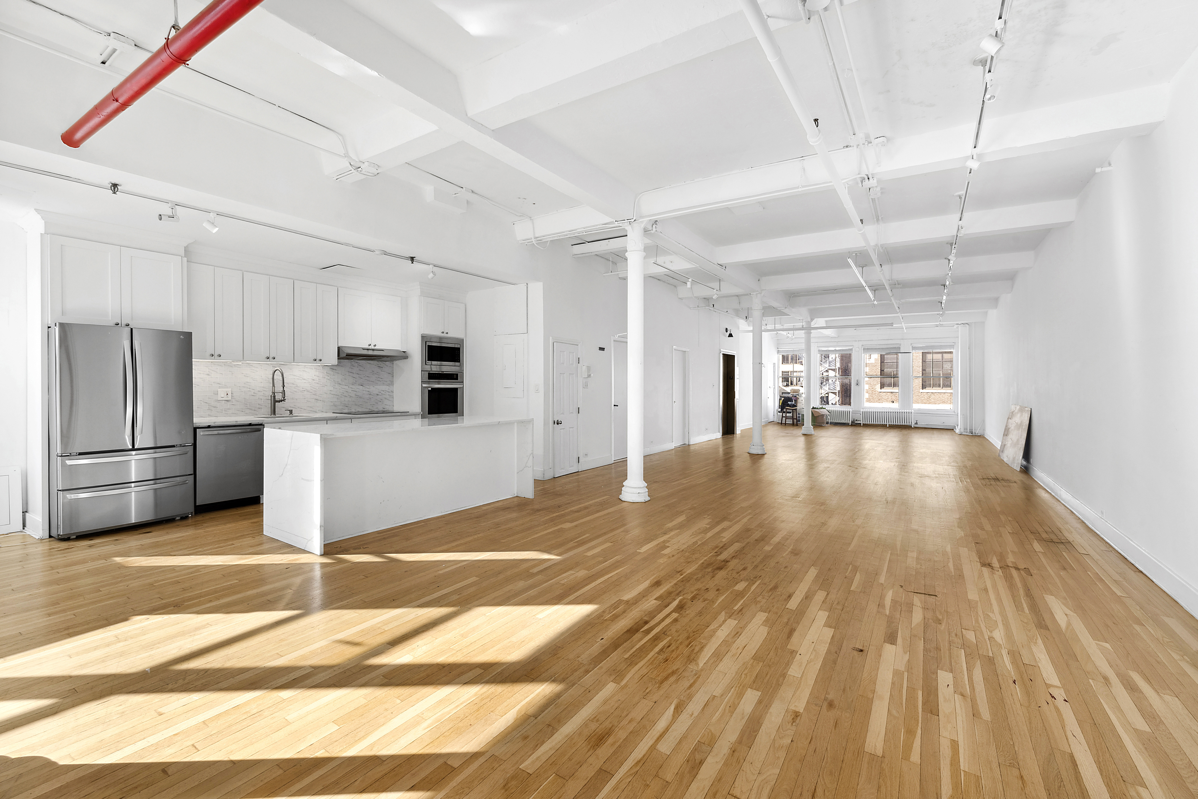 417 Lafayette Street, Unit 7 Manhattan, NY 10003 - Photo 1 of 1 a view of a kitchen with a sink and wooden floor