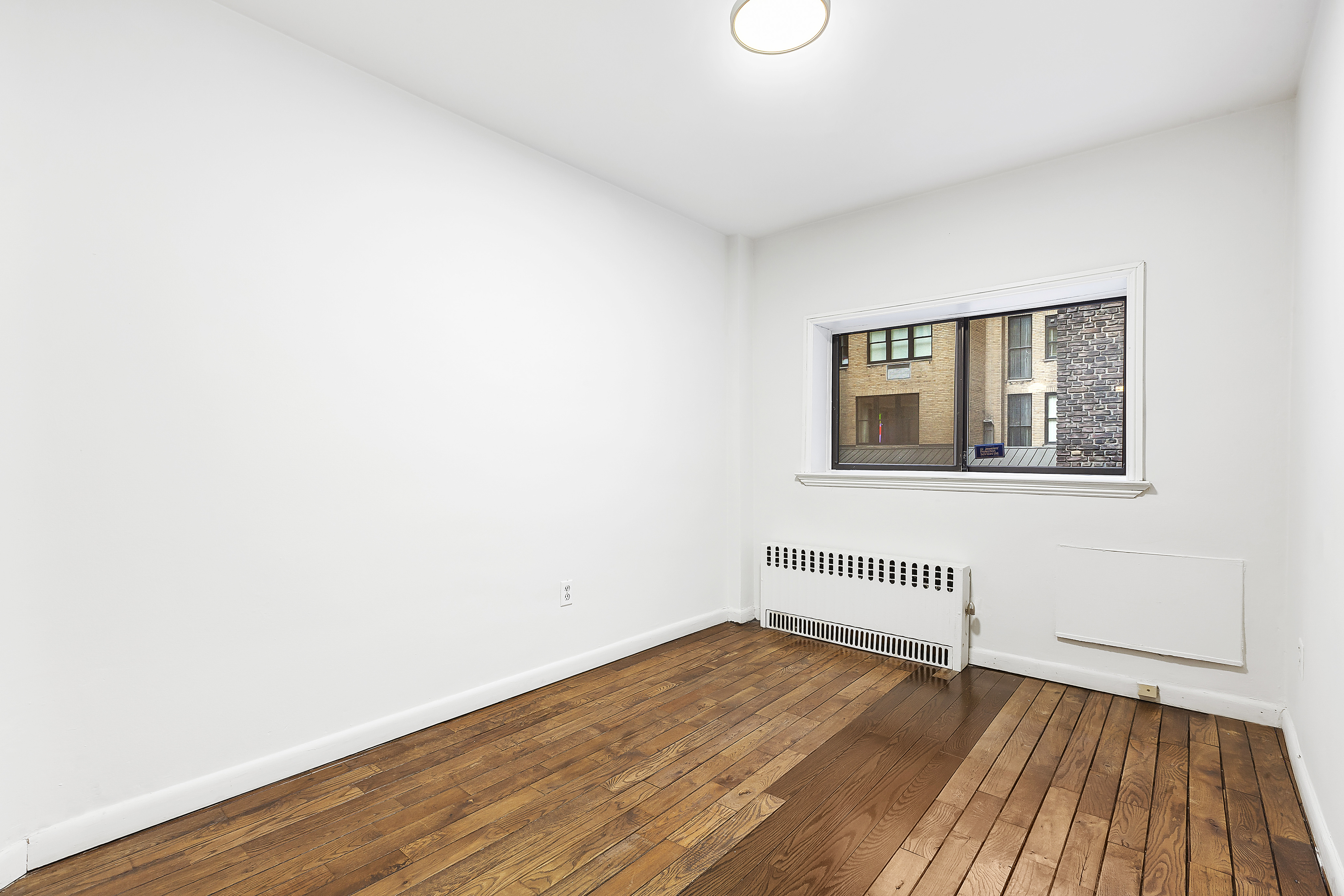59 East 74th Street, Unit 6A Manhattan, NY 10021 - Photo 3 of 5 a view of a room with wooden floor