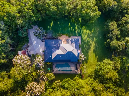an aerial view of a house with a yard