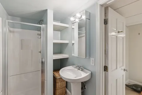 a bathroom with a sink toilet and shower