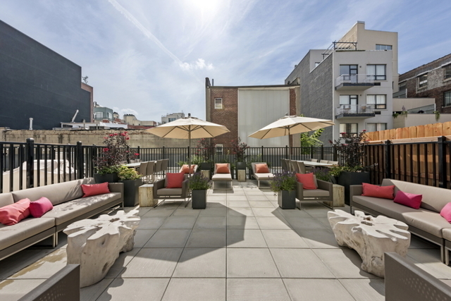 212 North 9th Street, Unit 3C Brooklyn, NY 11211 - Photo 13 of 16 a living room with furniture a fireplace and a chandelier