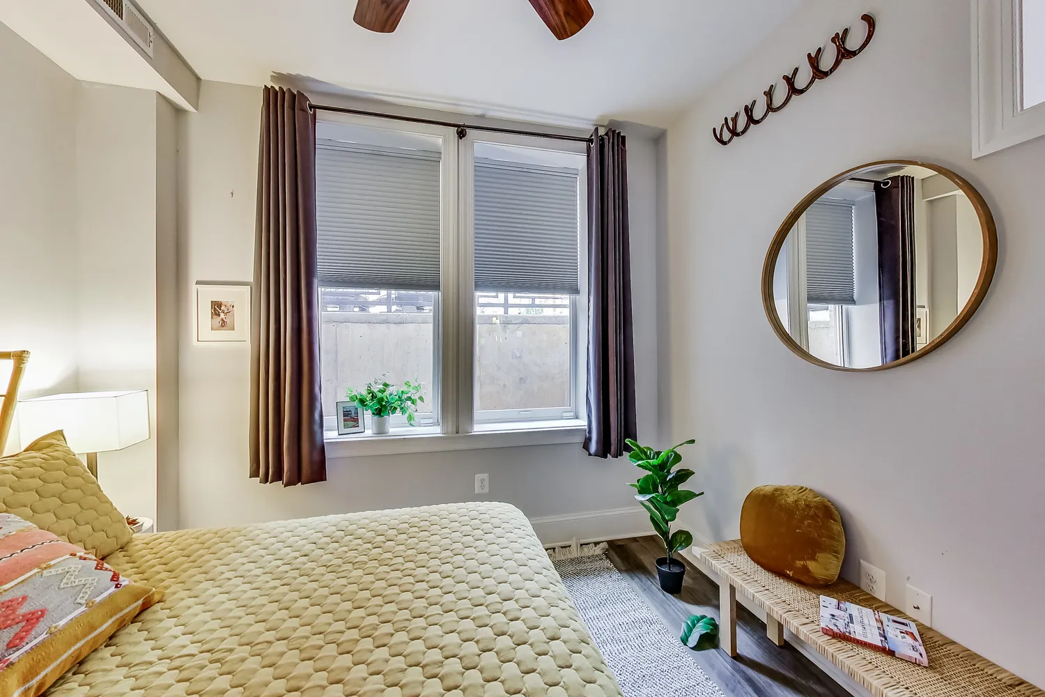 a bedroom with bed and a mirror