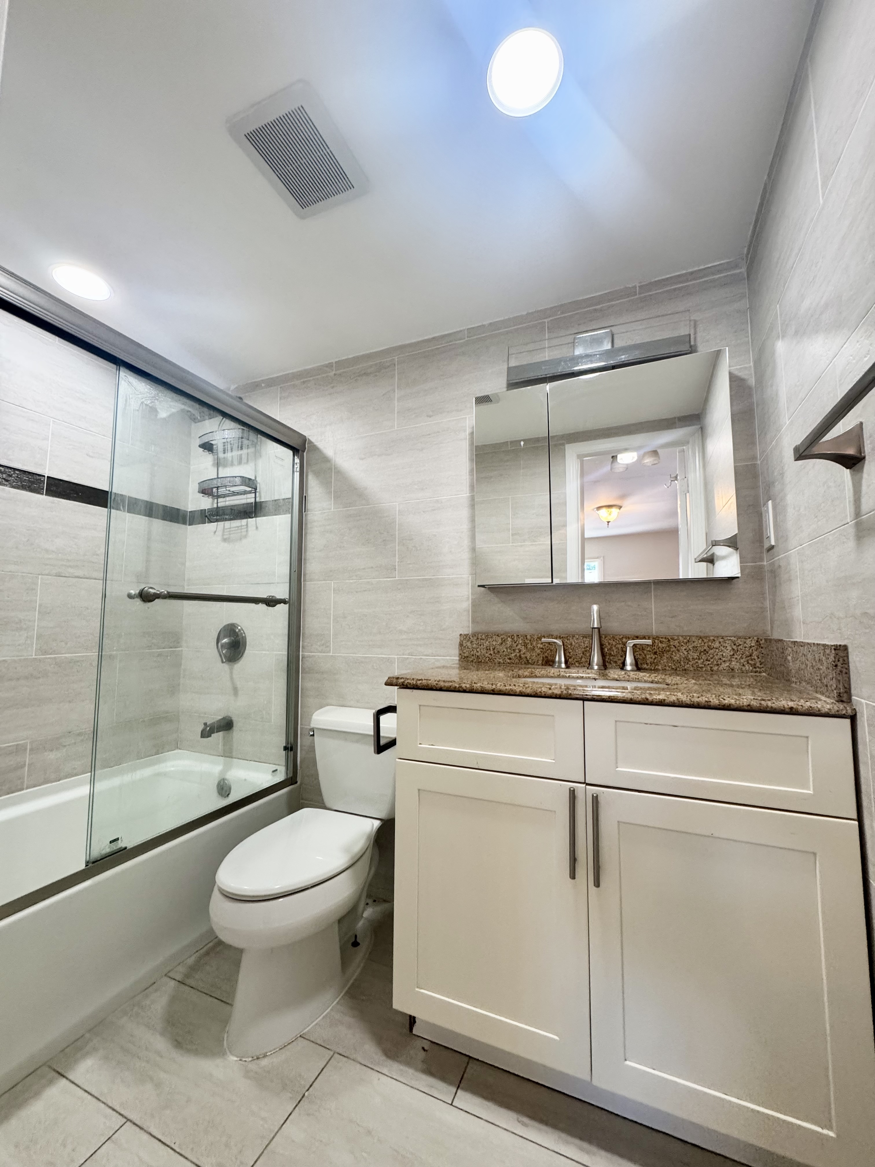 156-17 76th Street, Unit 1 Queens, NY 11414 - Photo 11 of 12 a bathroom with a toilet a sink and shower