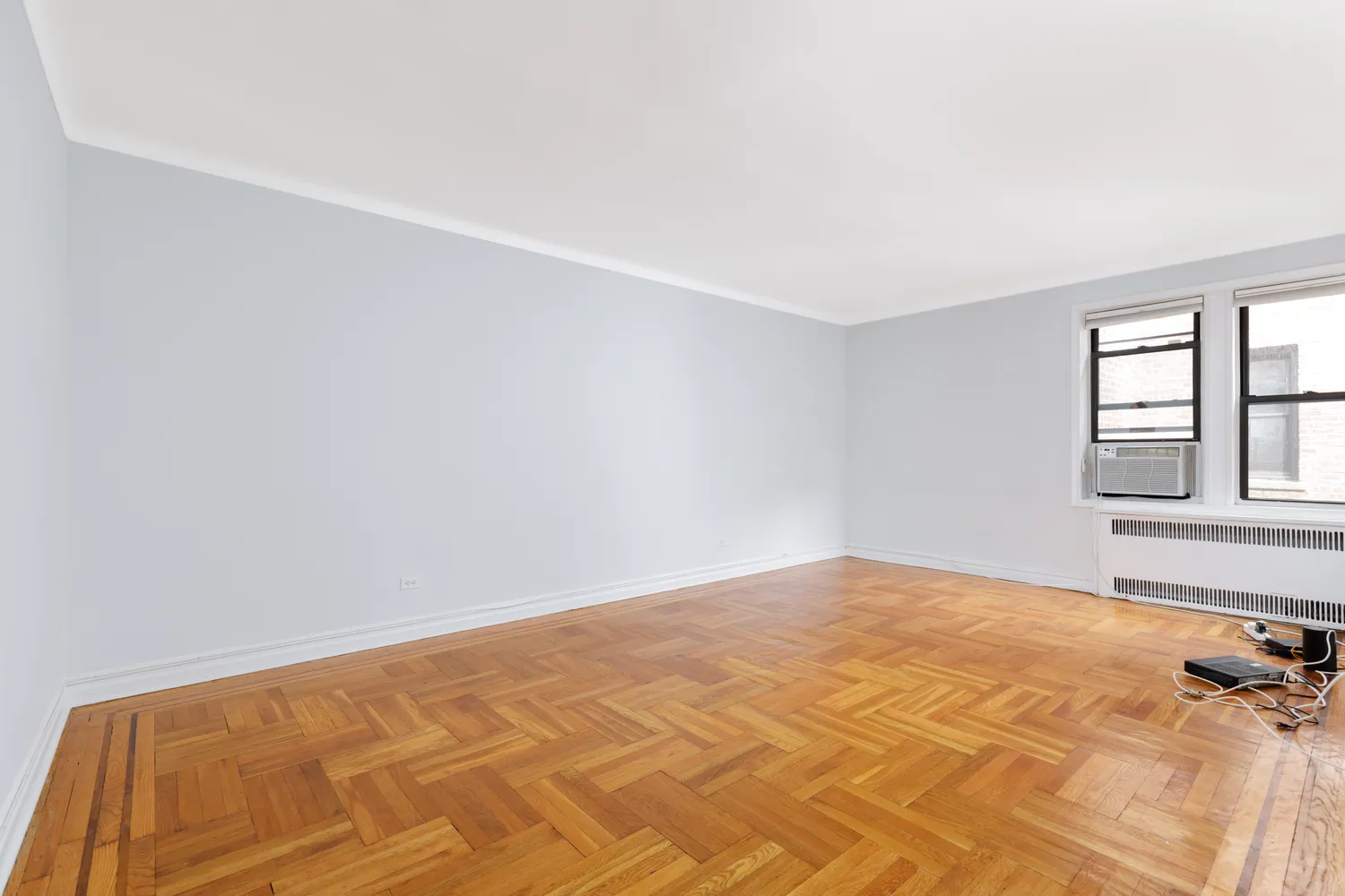 a view of a room with a bed and windows