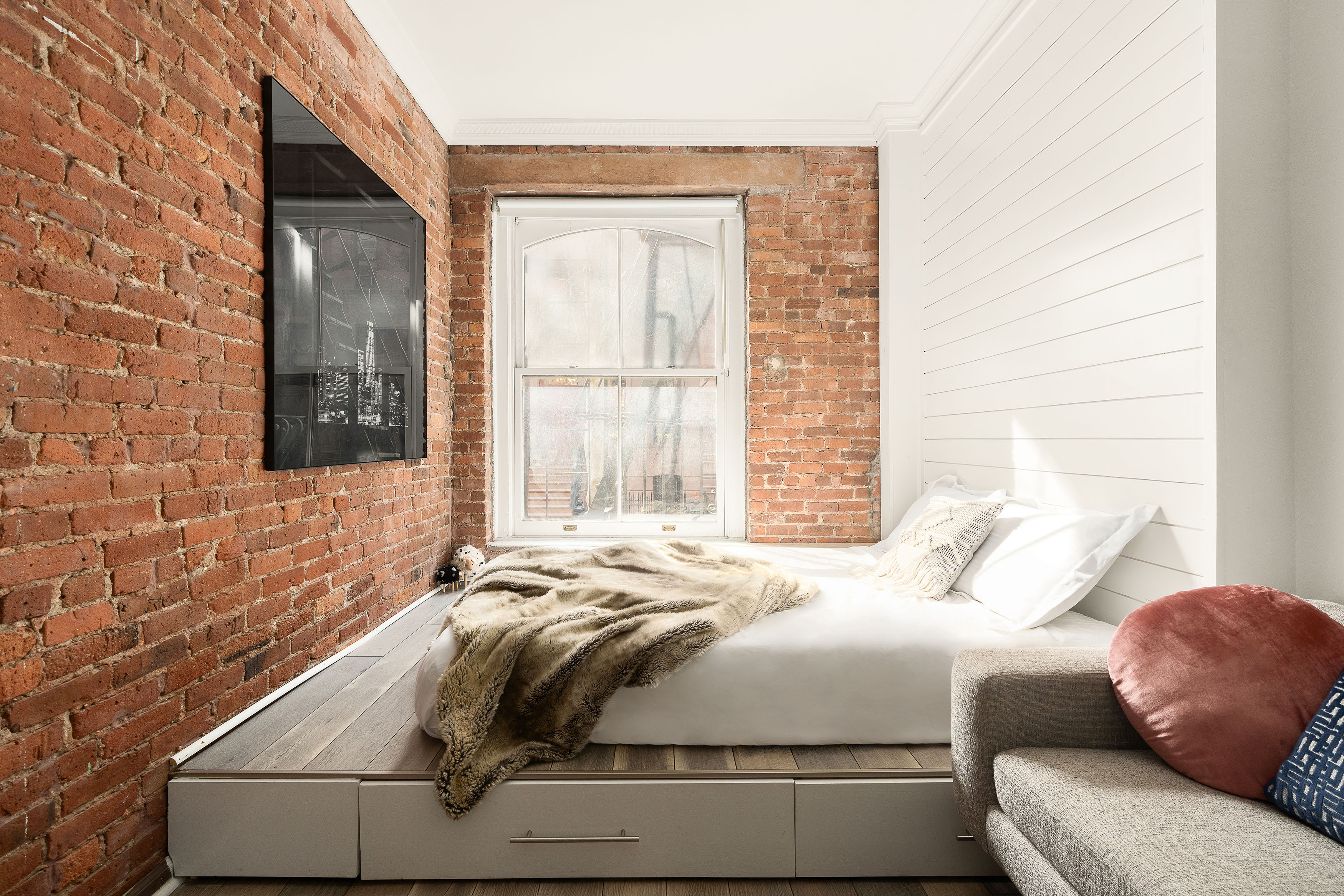 77 Perry Street, Unit 1A Manhattan, NY 10014 - Photo 3 of 6 a bedroom with a bed and with windows