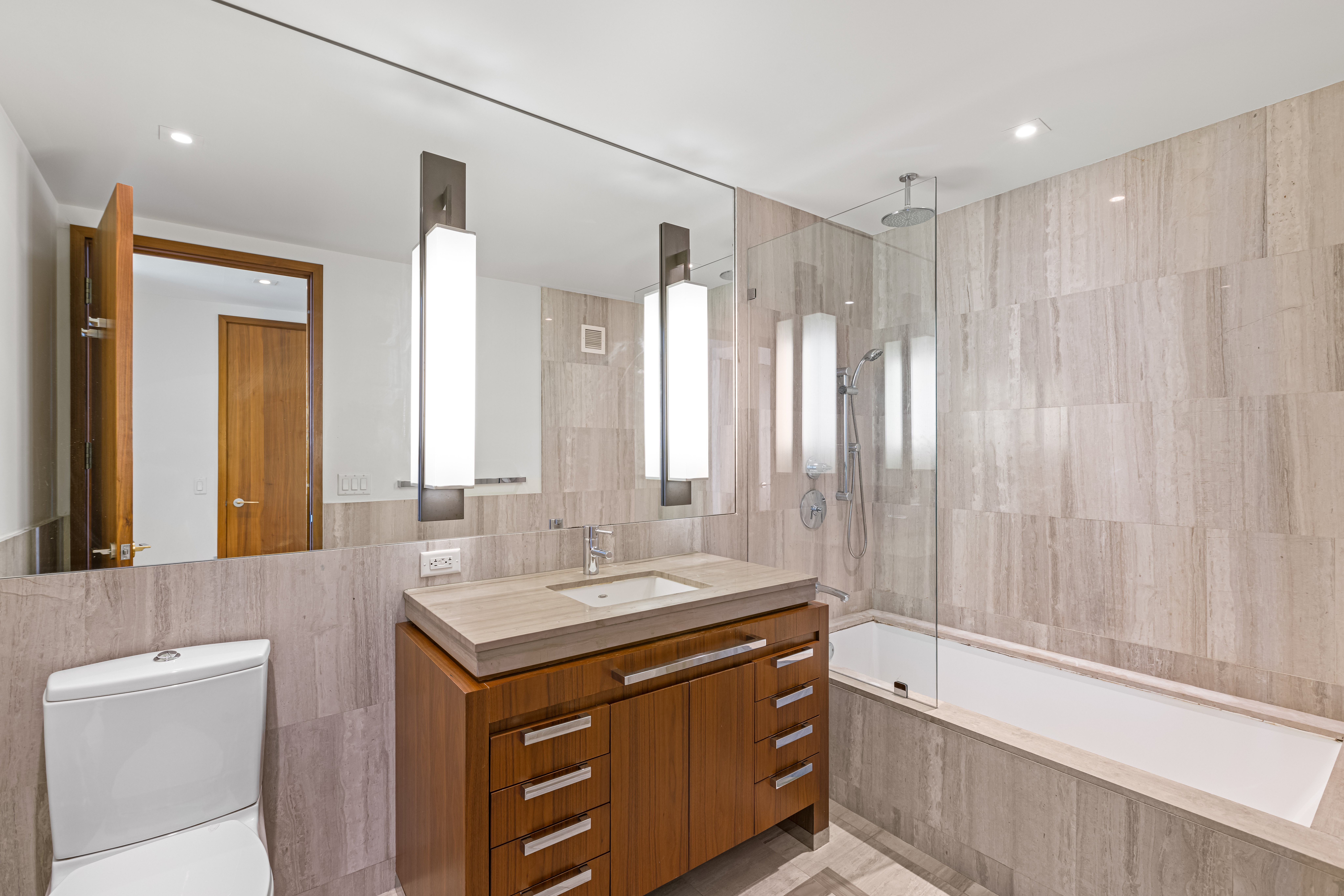 400 5th Avenue, Unit 49C Manhattan, NY 10018 - Photo 9 of 21 a bathroom with a double vanity sink and a mirror