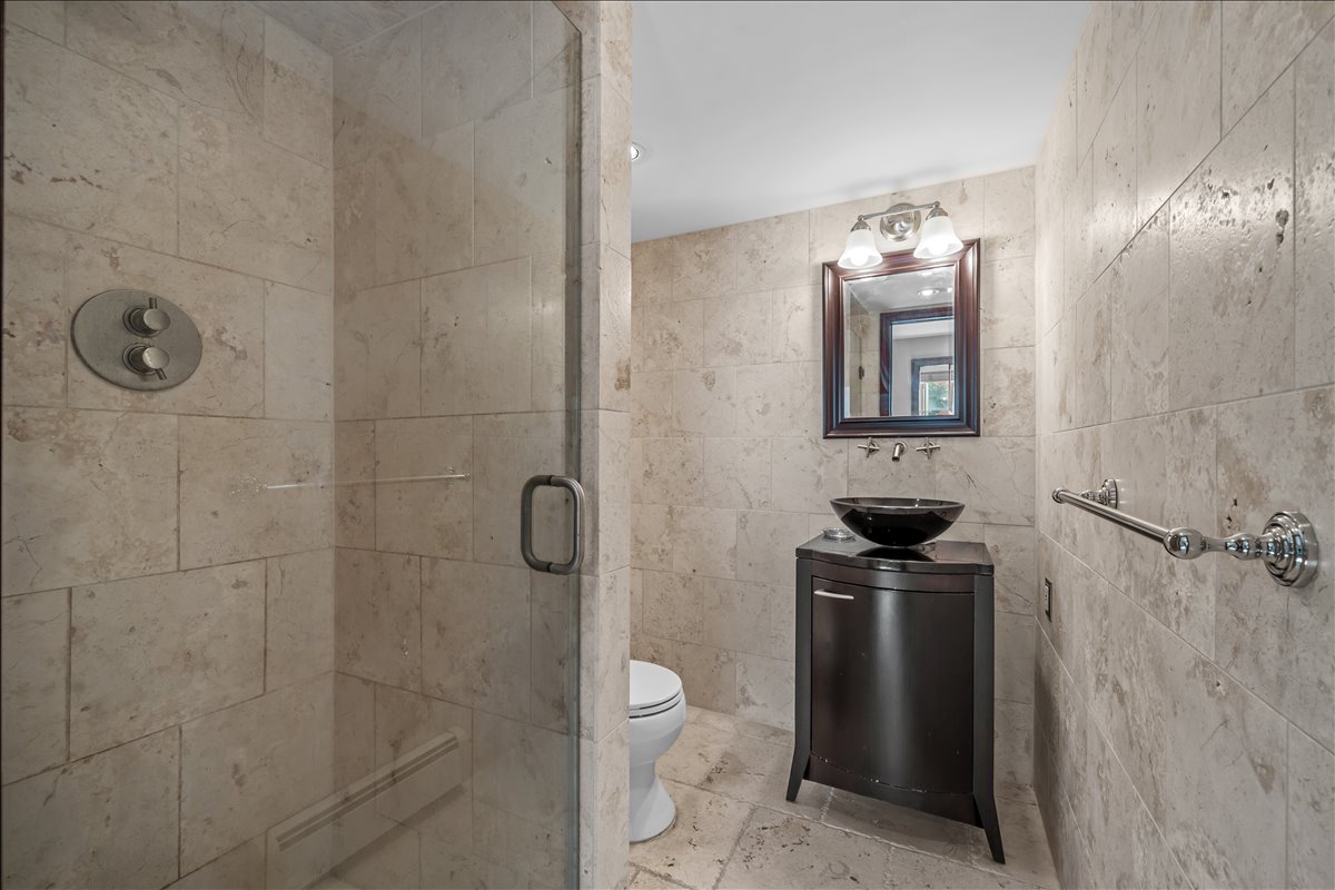 100-14 159th Avenue Queens, NY 11414 - Photo 8 of 26 a bathroom with a toilet a sink and shower