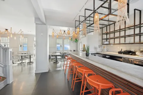 a living room with lots of furniture and a chandelier