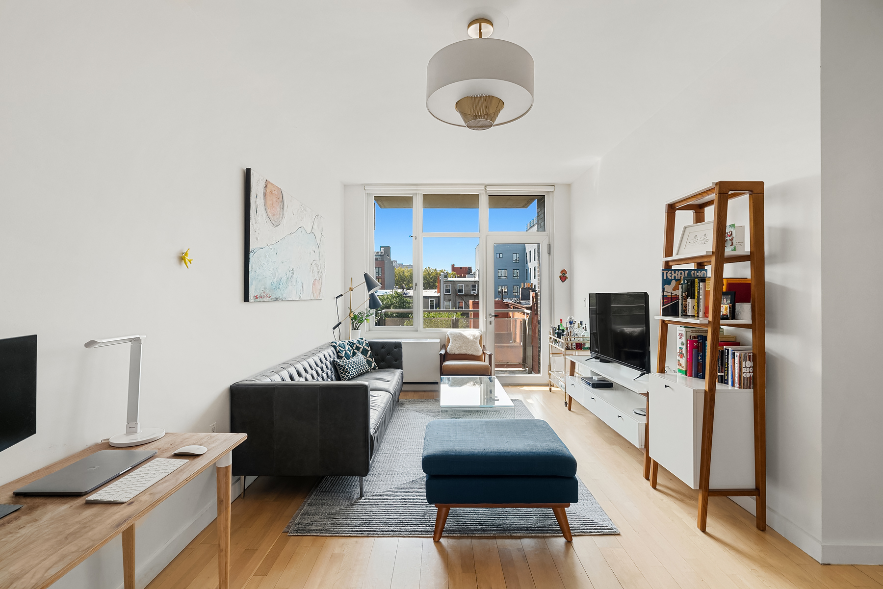 1 Powers Street, Unit 404 Brooklyn, NY 11211 - Photo 1 of 14 a living room with furniture and a flat screen tv