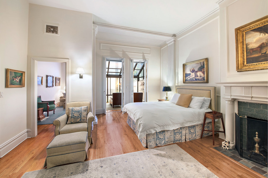 128 East 65th Street Manhattan, NY 10065 - Photo 8 of 10 a spacious bedroom with a bed and a couch