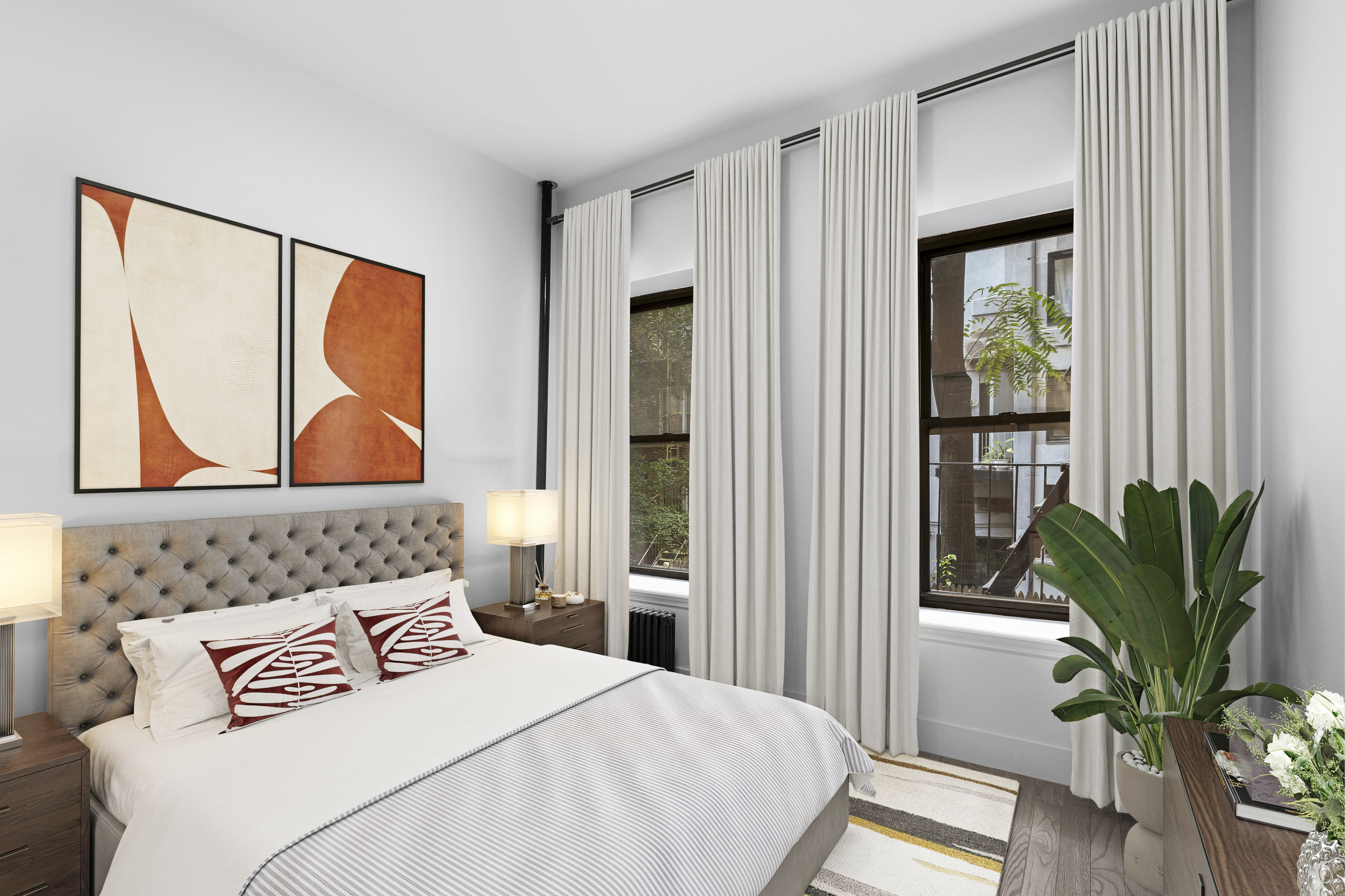 214 East 82nd Street, Unit 5 Manhattan, NY 10028 - Photo 1 of 2 a bedroom with a bed and a potted plant