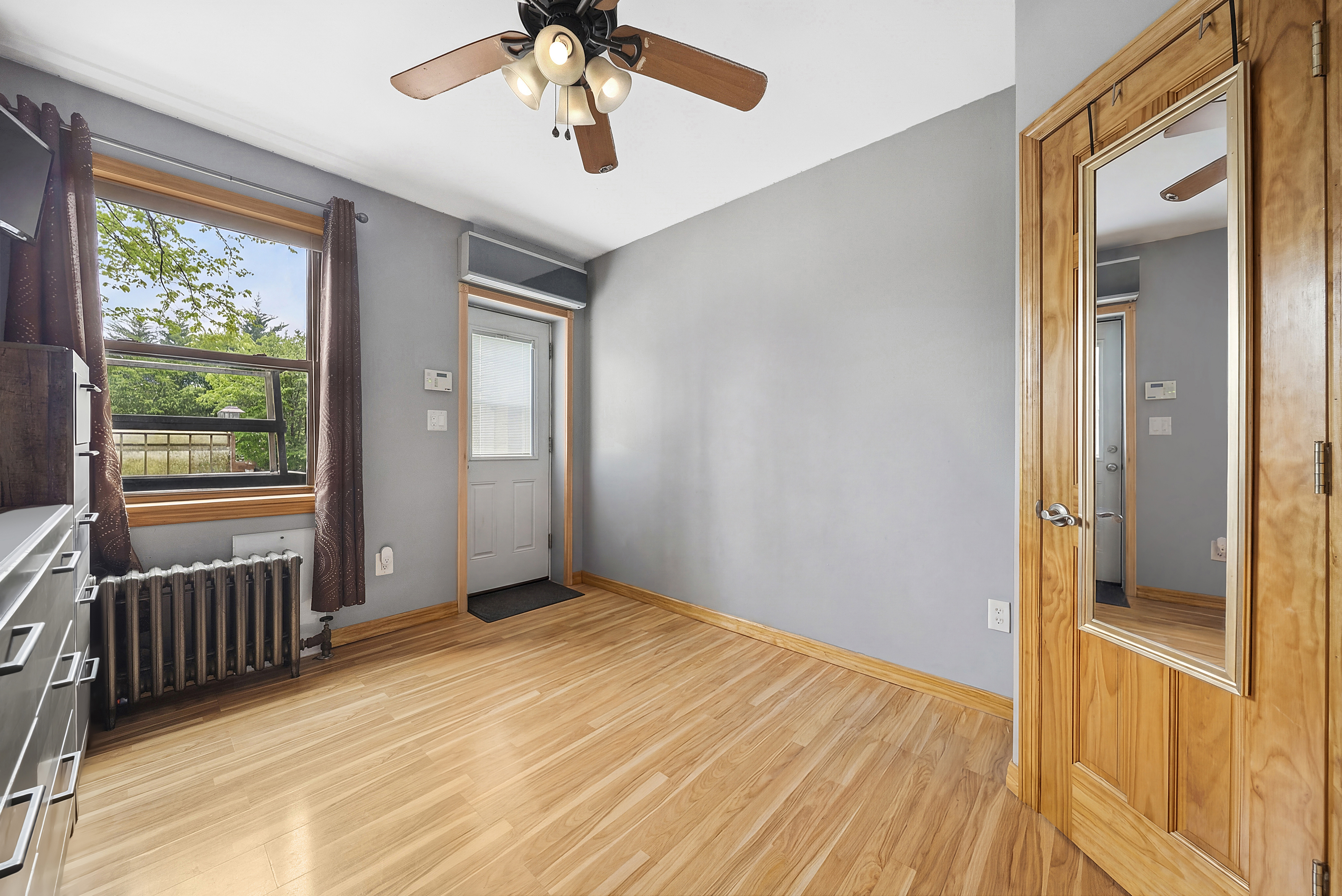 203 Battery Avenue Brooklyn, NY 11209 - Photo 6 of 14 wooden floor in an empty room with a window