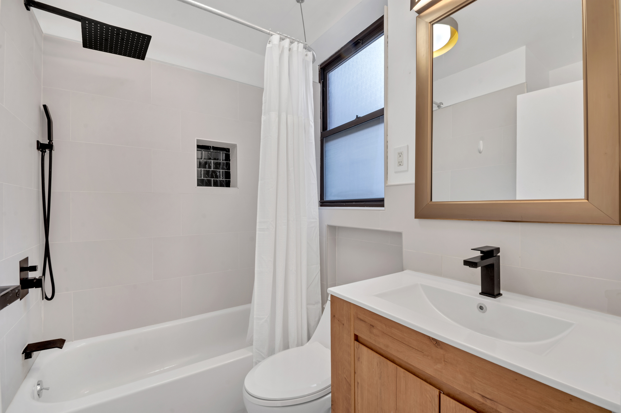 277 Nostrand Avenue, Unit 3A Brooklyn, NY 11216 - Photo 9 of 10 a bathroom with a sink a toilet and shower
