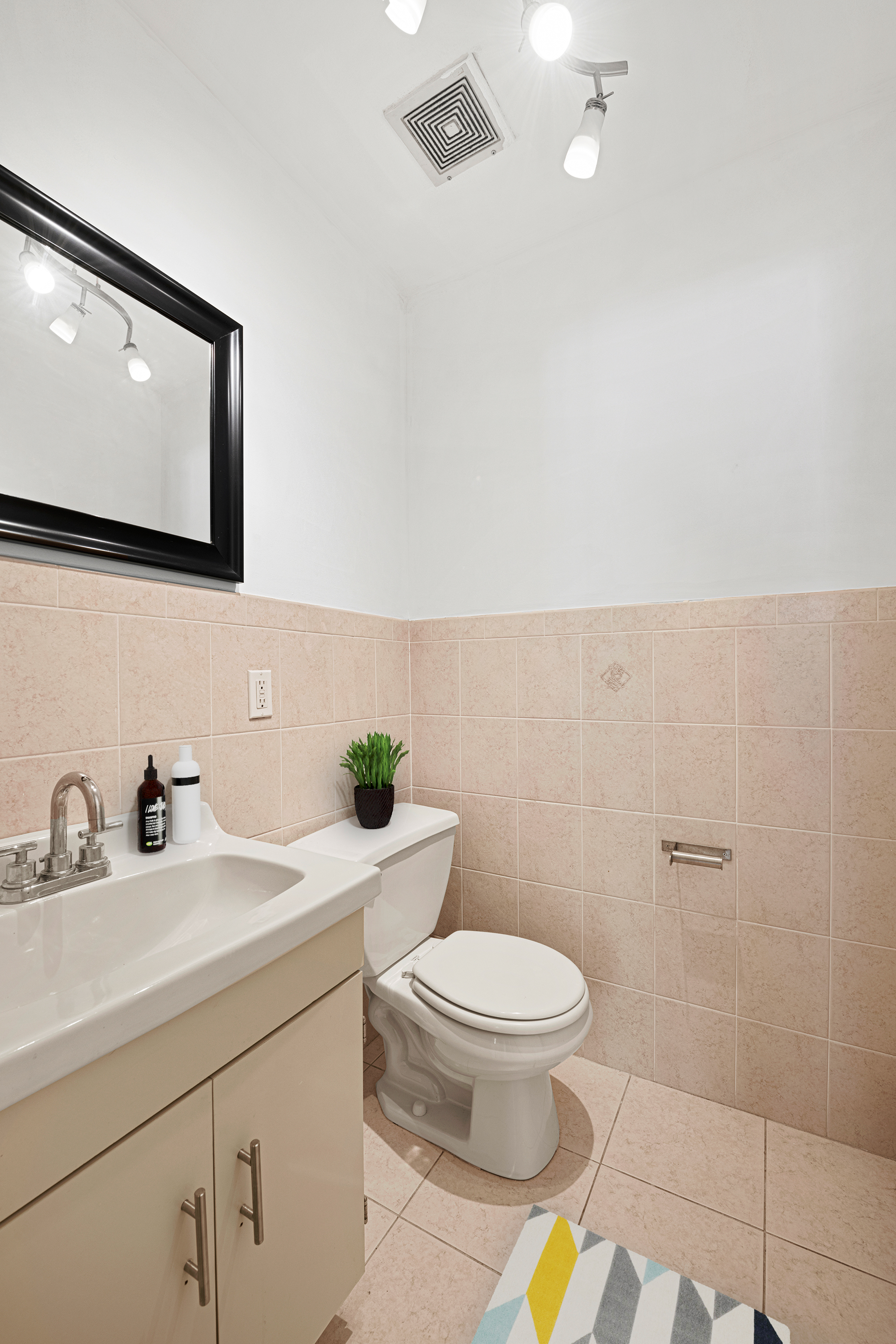 545 Gates Avenue, Unit 1 Brooklyn, NY 11216 - Photo 9 of 10 a bathroom with a toilet a sink and mirror