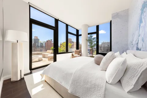 a bedroom with a large bed and a large window