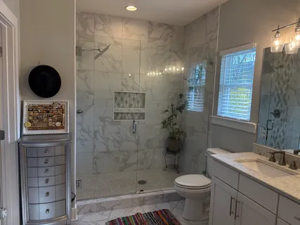 a bathroom with a shower toilet and sink
