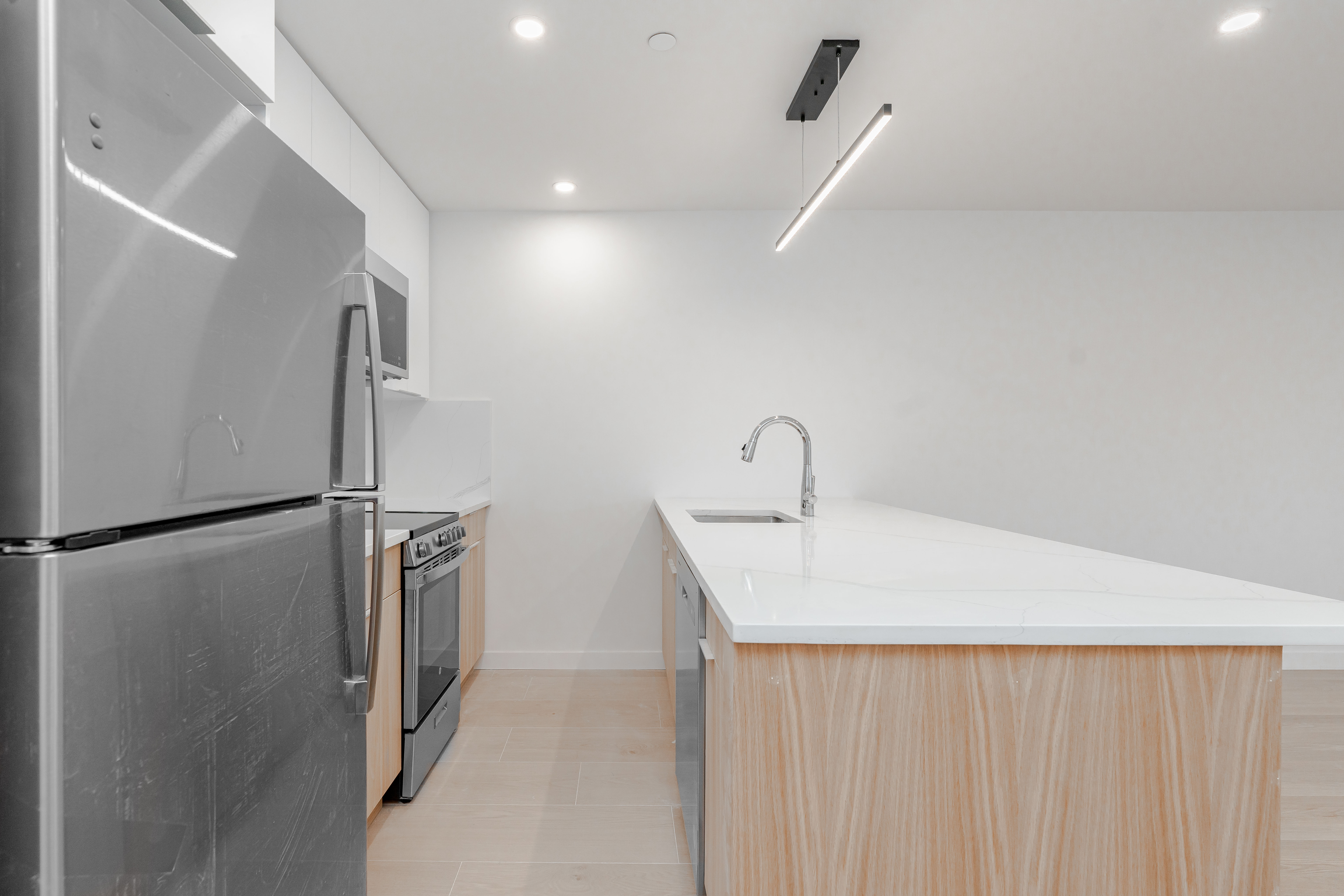 20-15 46th Street, Unit 2 Queens, NY 11105 - Photo 2 of 16 a kitchen with stainless steel appliances a refrigerator and a sink