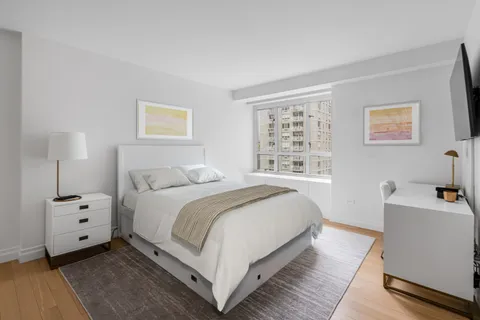 a bedroom with bed and a window