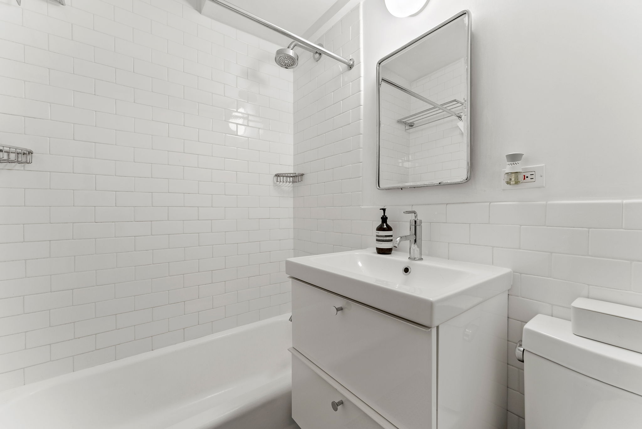 345 West 145th Street, Unit 11C2A Manhattan, NY 10031 - Photo 5 of 5 a bathroom with a sink a toilet and shower