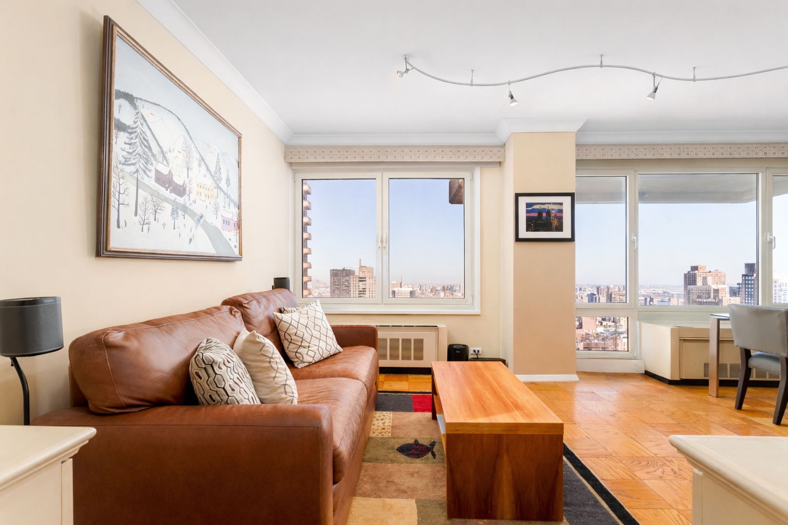50 East 89th Street, Unit 31C Manhattan, NY 10128 - Photo 6 of 18 a living room with furniture and a flat screen tv