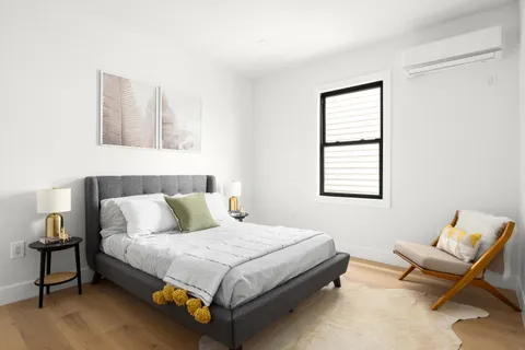 a bedroom with a bed and chair