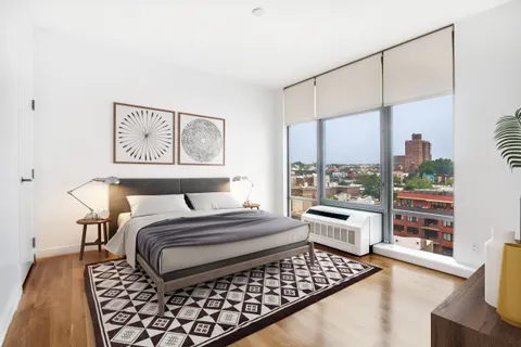 a bedroom with a large bed and a couch