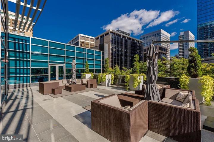 1881 North Nash Street, Unit 1009 Arlington, VA 22209 - Photo 28 of 36 a view of a house with a patio and a yard