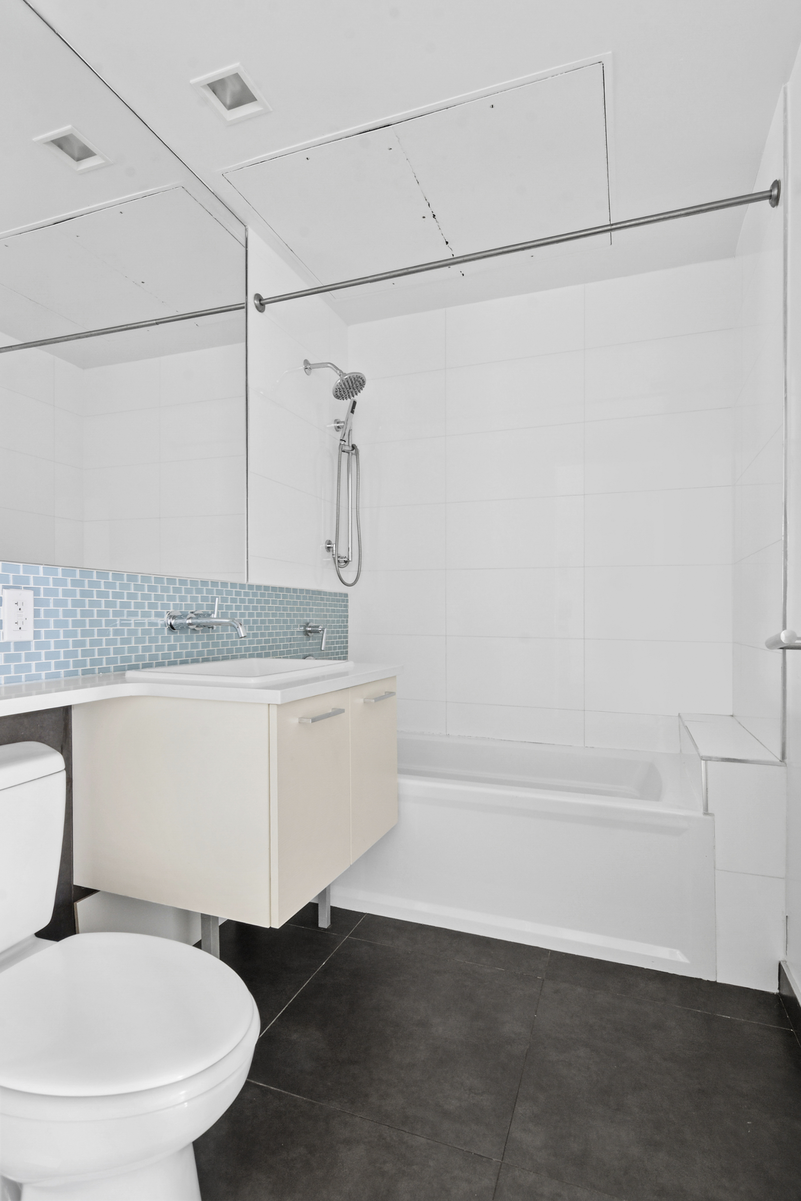 238 Saint Marks Avenue, Unit 2A Brooklyn, NY 11238 - Photo 5 of 6 a bathroom with a granite countertop sink and a mirror
