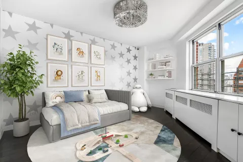 a bedroom with furniture and a large window