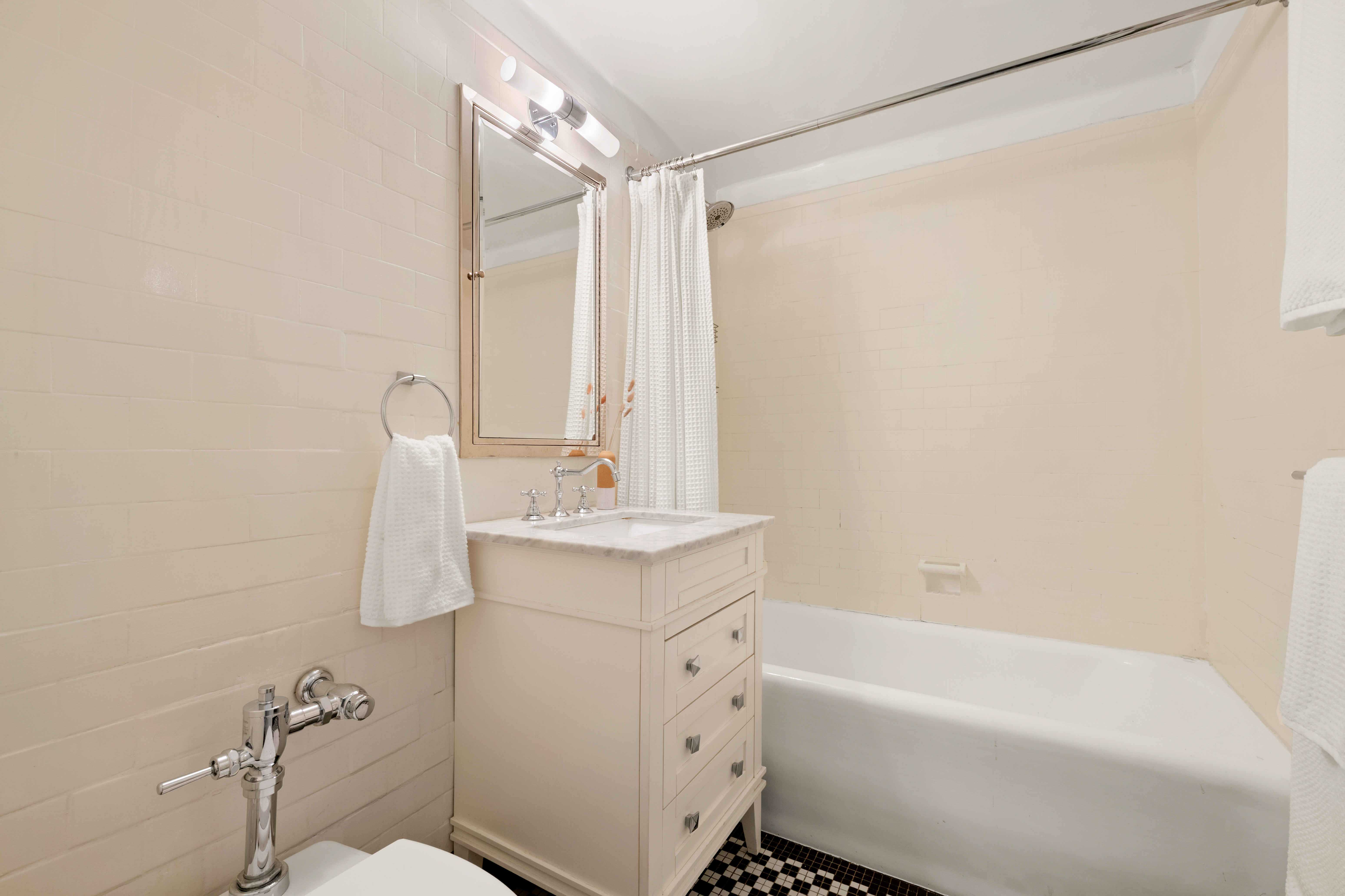 465 West 23rd Street, Unit 2G Manhattan, NY 10011 - Photo 6 of 11 a bathroom with a sink toilet and shower