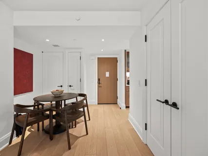 a view of a a dining room with furniture window and wooden floor