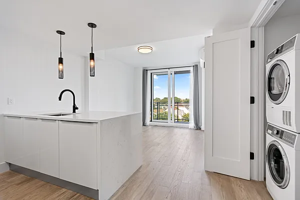 a view of a sink and a washer in a room