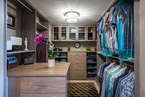 a view of walk in closet with clothes and shoes