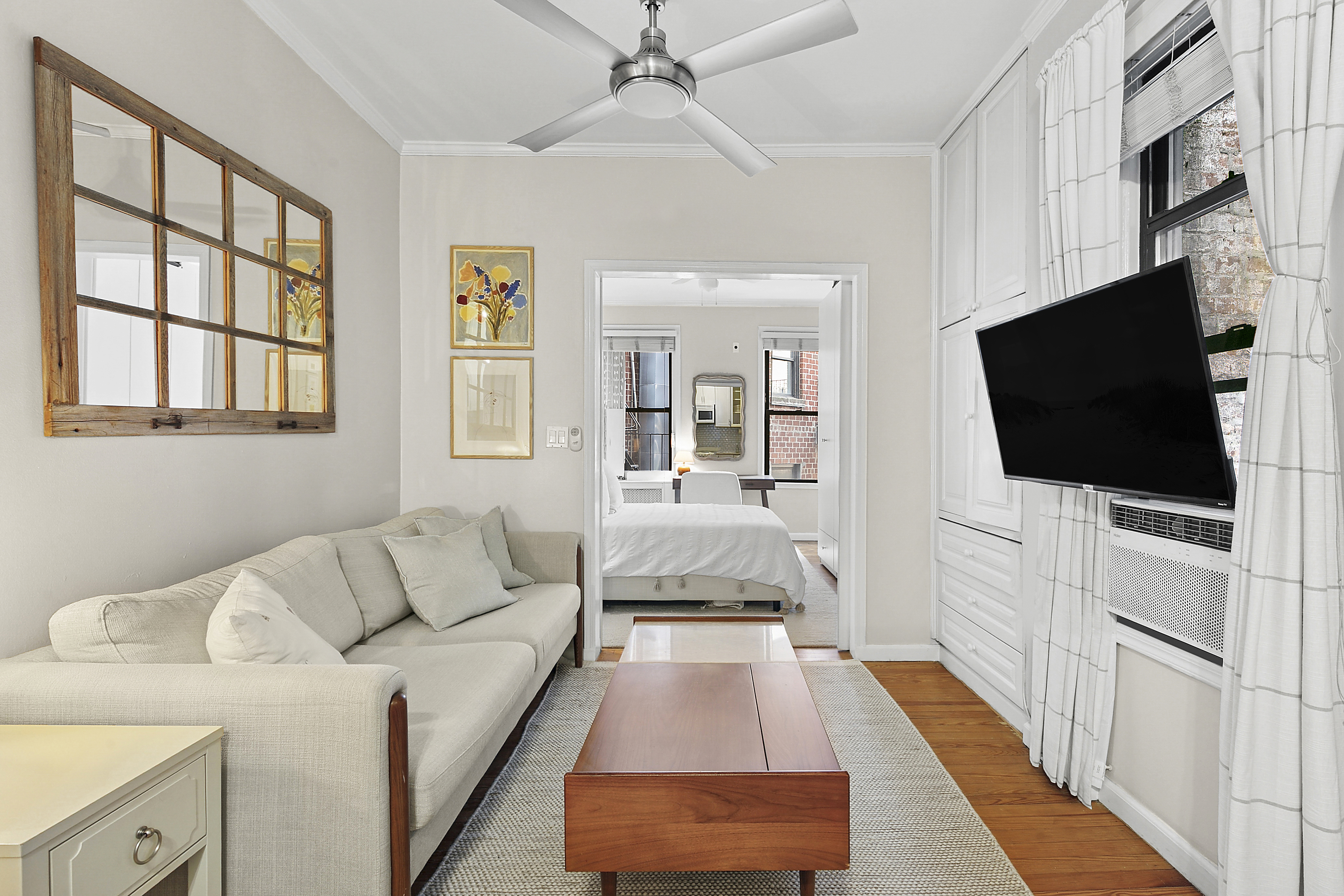 25 Leroy Street, Unit 11 Manhattan, NY 10014 - Photo 1 of 4 a living room with furniture and a flat screen tv