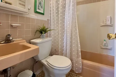 a bathroom with a sink a toilet and bathtub