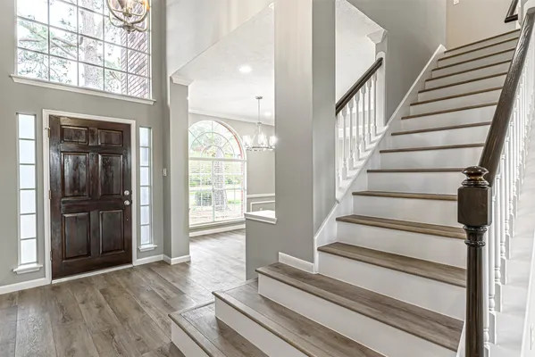 a view of entryway and hall with wooden floor