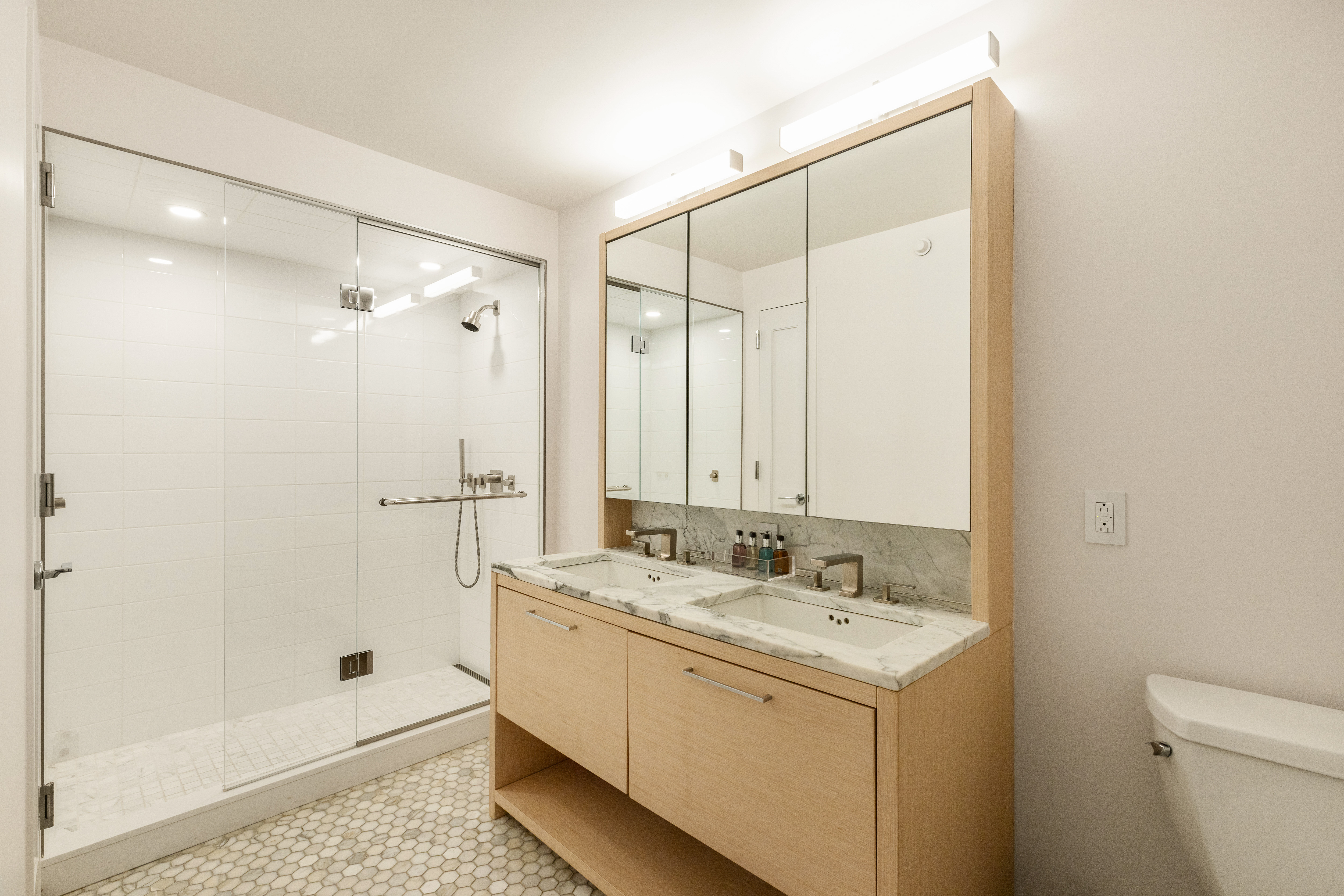 101 West 87th Street, Unit 415 Manhattan, NY 10024 - Photo 7 of 10 a bathroom with a shower sink and mirror