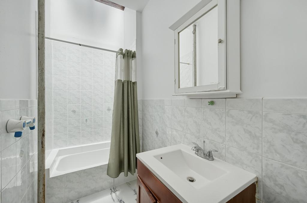 10 Seeley Street Brooklyn, NY 11218 - Photo 20 of 27 a bathroom with a sink a toilet and shower