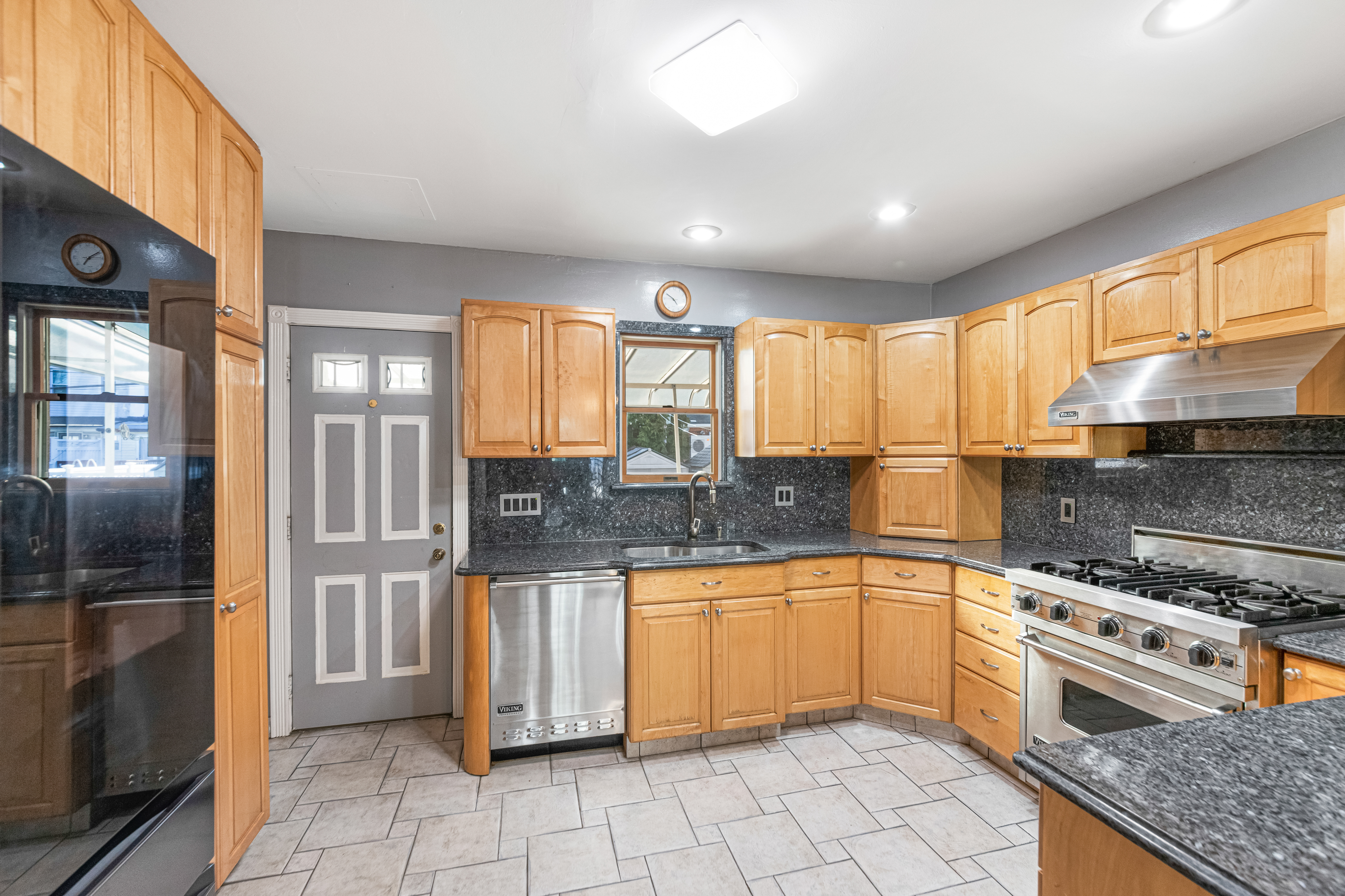 1874 Ryder Street Brooklyn, NY 11234 - Photo 7 of 20 a kitchen with stainless steel appliances granite countertop a stove a sink and a refrigerator