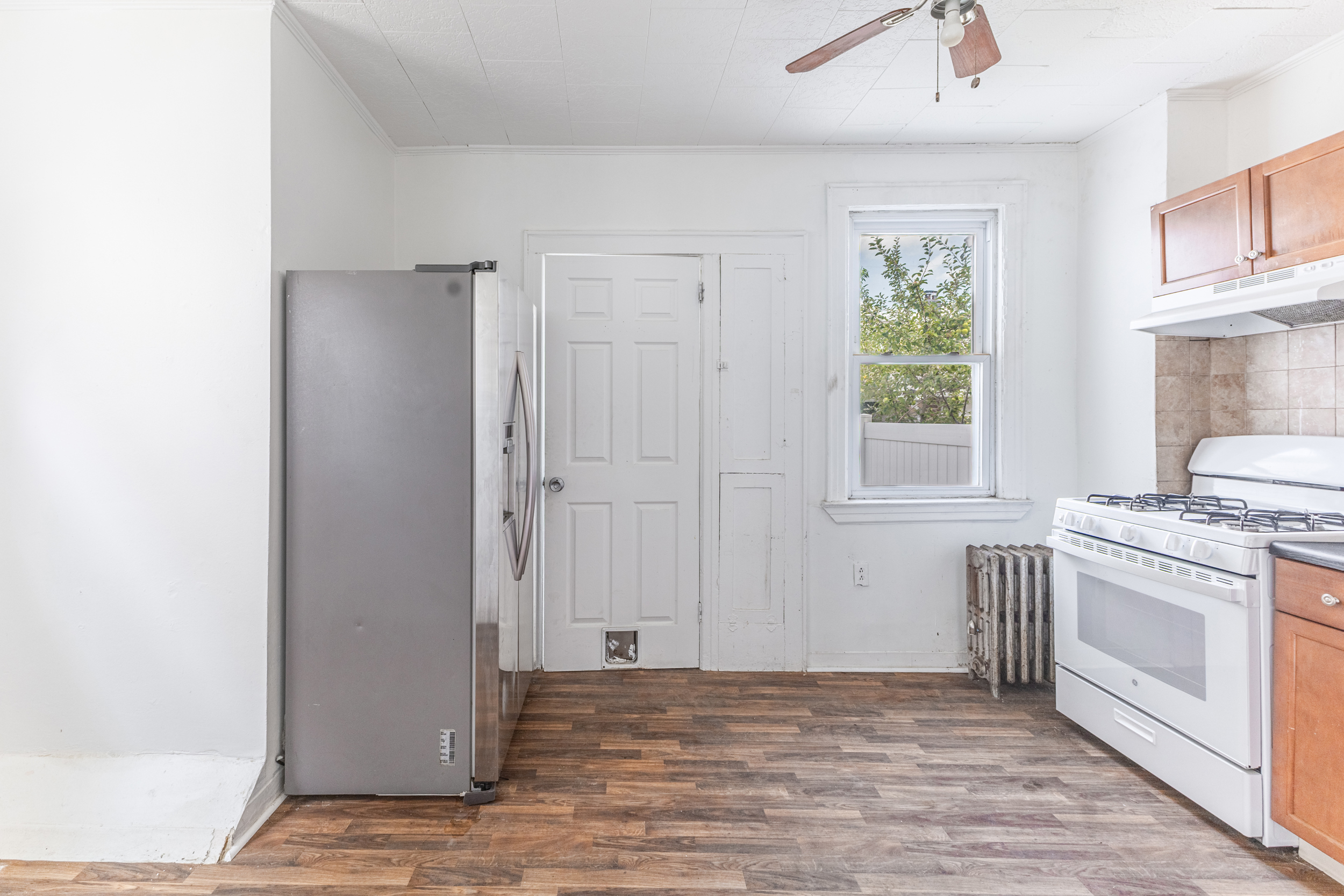69-29 67th Place Queens, NY 11385 - Photo 12 of 24 a view of a kitchen with a sink and a stove top oven