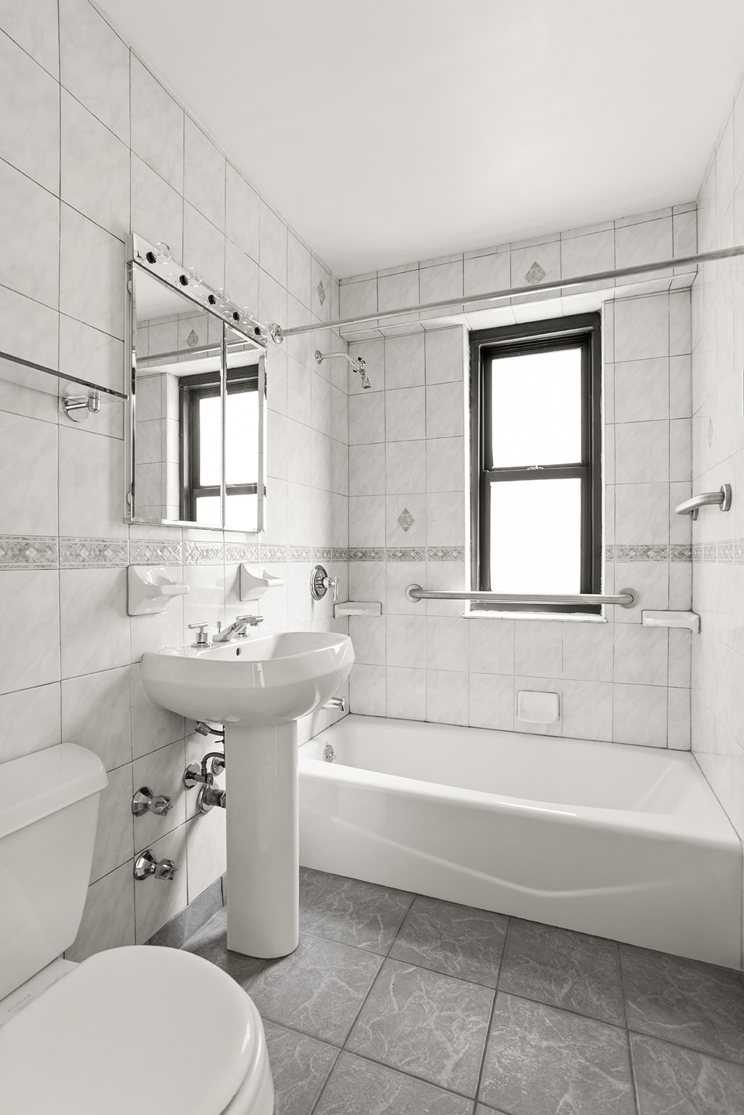 385 Grand Street, Unit L207 Manhattan, NY 10002 - Photo 8 of 12 a bathroom with a sink toilet and shower